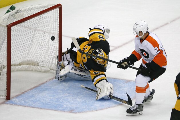 Philadelphia Flyers' Matt Read (24) backhands a shot over Pittsburgh Penguins goalie Marc-Andre Fleury (29) for a goal in the third period of an NHL hockey game in Pittsburgh, Wednesday, Oct. 22, 2014. The Flyers won 5-3. (AP Photo/Gene J. Puskar)