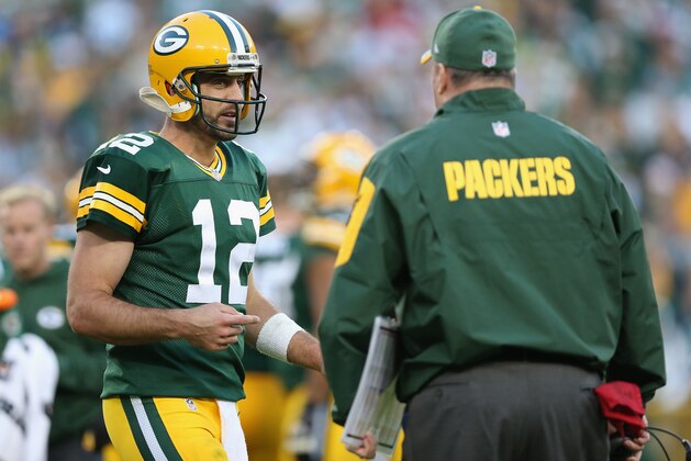 GREEN BAY, WI - SEPTEMBER 14:  Quarterback Aaron Rodgers #12 of the Green Bay Packers talks with head coach Mike McCarthy during the NFL game against the New York Jets at Lambeau Field on September 14, 2014 in Green Bay, Wisconsin. The Packers defeated the Jets 31-24.  (Photo by Christian Petersen/Getty Images)