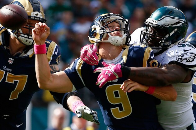 Philadelphia Eagles' Trent Cole, right, knocks the ball loose from St. Louis Rams' Austin Davis (9) during the second half of an NFL football game, Sunday, Oct. 5, 2014, in Philadelphia. Philadelphia recovered the fumble and scored on the play. (AP Photo/Matt Rourke)