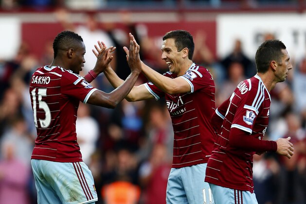 LONDON, ENGLAND - OCTOBER 05:  Diafra Sakho of West Ham celebrate with team-mate Stewart Downing after scoring his team's second goal during the Barclays Premier League match between West Ham United and Queens Park Rangers at Boleyn Ground on October 5, 2014 in London, England.  (Photo by Julian Finney/Getty Images)