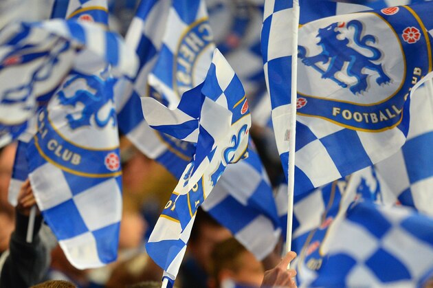 LONDON, ENGLAND - APRIL 08:  Chelsea fans wave flags during the UEFA Champions League Quarter Final second leg match between Chelsea and Paris Saint-Germain FC at Stamford Bridge on April 8, 2014 in London, England.  (Photo by Mike Hewitt/Getty Images)