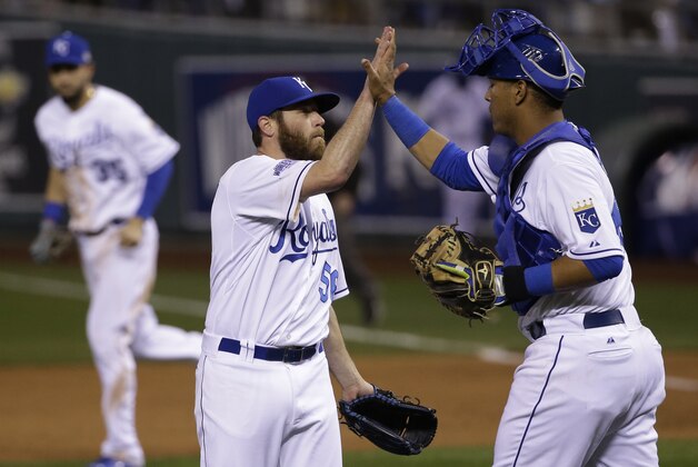 Kansas City Royals pitcher Greg Holland, left is congratulated by Salvador Perez after their 7-2 victory of the San Francisco Giants in  Game 2 of baseball's World Series Wednesday, Oct. 22, 2014, in Kansas City, Mo. The series is tied 1-1 games. (AP Photo/Matt Slocum)