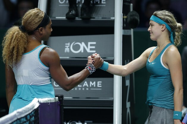 Serena Williams, left, of the US is congratulated by Canada's Eugenie Bouchard following their singles match at the WTA tennis finals in Singapore,Thursday, Oct. 23, 2014. (AP Photo/Mark Baker)