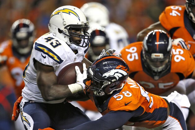 San Diego Chargers running back Branden Oliver (43) is hit by Denver Broncos outside linebacker Von Miller (58) during the first half of an NFL football game, Thursday, Oct. 23, 2014, in Denver. (AP Photo/Joe Mahoney)