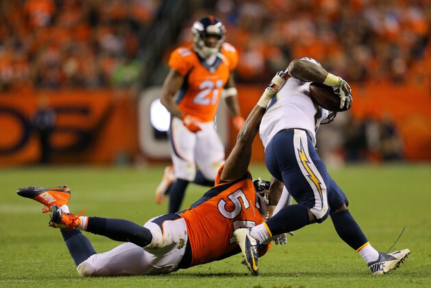 DENVER, CO - OCTOBER 23:  Outside linebacker Brandon Marshall #54 of the Denver Broncos tackles running back Branden Oliver #43 of the San Diego Chargers for a loss during a game at Sports Authority Field at Mile High on October 23, 2014 in Denver, Colorado.  (Photo by Justin Edmonds/Getty Images)
