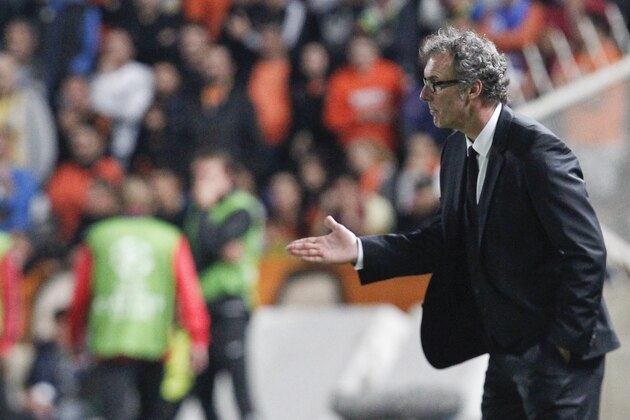 PSG's coach Laurent Blanc gives instruction to his players during the Champions League Group F soccer match between Apoel and Paris Saint Germain, at GSP stadium, Tuesday, Oct. 21, 2014. (AP Photo/Petros Karadjias)