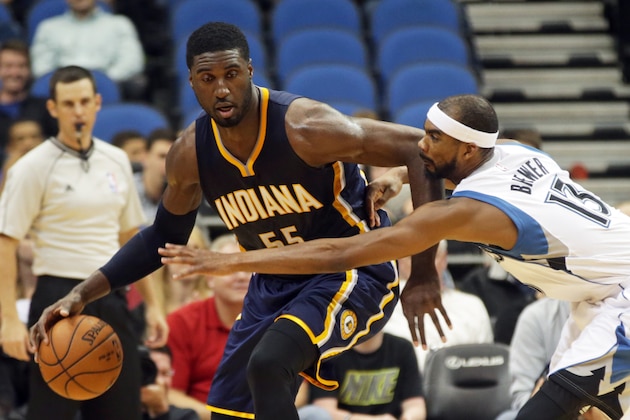 Indiana Pacers'  Roy Hibbert, left, keeps the ball away from Minnesota Timberwolves' Corey Brewer in the second half of a preseason NBA basketball game, Tuesday, Oct. 21, 2014, in Minneapolis. The Timberwolves won 107-89. (AP Photo/Jim Mone)