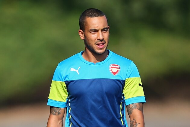 ST ALBANS, ENGLAND - SEPTEMBER 30:  Theo Walcott of Arsenal walks out for training during an Arsenal training session ahead of their UEFA Champions League Group D match against Galatasaray at London Colney on September 30, 2014 in St Albans, England.  (Photo by Paul Gilham/Getty Images)
