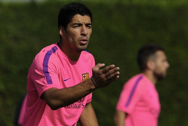 FC Barcelona's Luis Suarez, from Uruguay, gestures during a training session at the Sports Center FC Barcelona Joan Gamper in San Joan Despi, Spain, Saturday, Aug. 23, 2014. (AP Photo/Manu Fernandez)