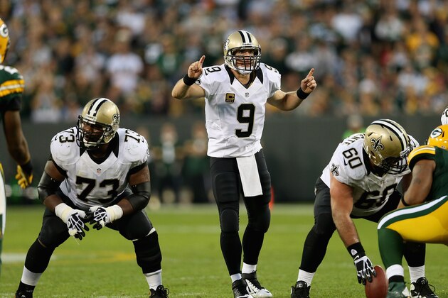 GREEN BAY, WI - SEPTEMBER 30: Drew Brees #9 of the New Orleans Saints calls a play as Jahri Evans #73 and Brian de la Puente #60 await the snap against the Green Bay Packers at Lambeau Field on September 30, 2012 in Green Bay, Wisconsin. The Packers defeated the Saints 28-27.  (Photo by Jonathan Daniel/Getty Images)