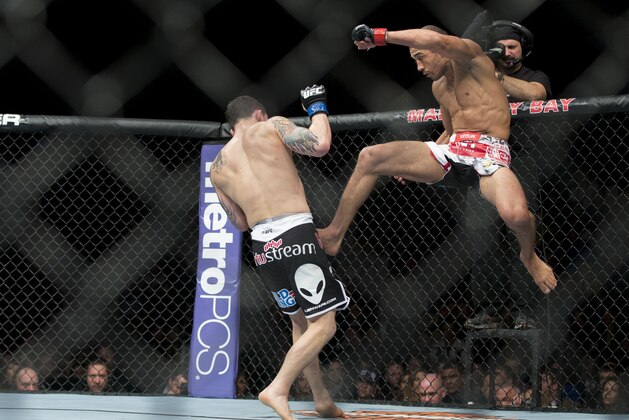 Jose Aldo, of Rio de Janeiro, kicks Frankie Edgar during their UFC 156 featherweight mixed martial arts title match, Saturday, Feb. 2, 2013 at The Mandalay Bay Resort & Casino in Las Vegas. Aldo won by unanimous decision. (AP Photo/Eric Jamison)