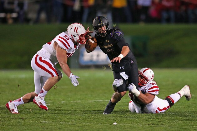 EVANSTON, IL - OCTOBER 18:  Trevor Siemian #13 of the Northwestern Wildcats fumbles the ball as he is sacked by Jack Gangwish #95 (L) and Kevin Williams #92 of the Nebraska Cornhuskers of the Nebraska Cornhuskers at Ryan Field on October 18, 2014 in Evanston, Illinois. Nebraska defeated Northwestern 38-17.  (Photo by Jonathan Daniel/Getty Images)