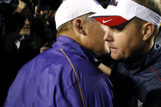 Mississippi head coach Hugh Freeze, left, talks with LSU head coach Les Miles after their NCAA college football game in Baton Rouge, La., Saturday, Nov. 17, 2012. LSU won 41-35. (AP Photo/Gerald Herbert)