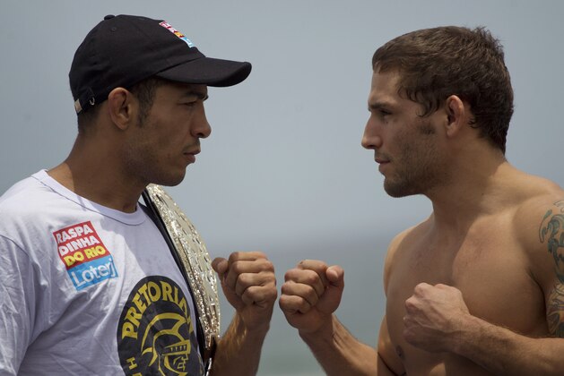 Jose Aldo, of Brazil, left, and Chad Mendes, of the U.S., pose together during the UFC Rio Open Workouts event on Barra de Tijuca Beach in Rio de Janeiro, Brazil, Wednesday Jan. 11, 2012.  Aldo and Mendes will face each other on Jan. 14 at the Ultimate Fighting Championship's UFC 142, the organization's second event in Rio de Janeiro.  (AP Photo/Felipe Dana)