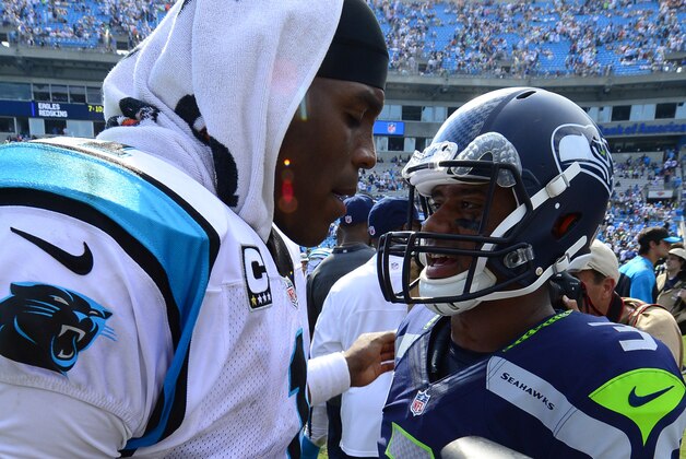 Sep 8, 2013; Charlotte, NC, USA; Carolina Panthers quarterback Cam Newton (1) talks with Seattle Seahawks quarterback Russell Wilson (3) after the game. The Seahawks defeated the Panthers 12-7 at Bank of America Stadium. Mandatory Credit: Bob Donnan-USA TODAY Sports