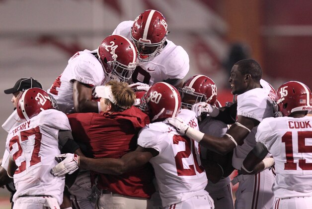Oct 11, 2014; Fayetteville, AR, USA; Alabama Crimson Tide defensive back Landon Collins (26) is covered up by teammates after an interception against the Arkansas Razorbacks during the fourth quarter at Donald W. Reynolds Razorback Stadium. Alabama defeated Arkansas 14-13. Mandatory Credit: Nelson Chenault-USA TODAY Sports