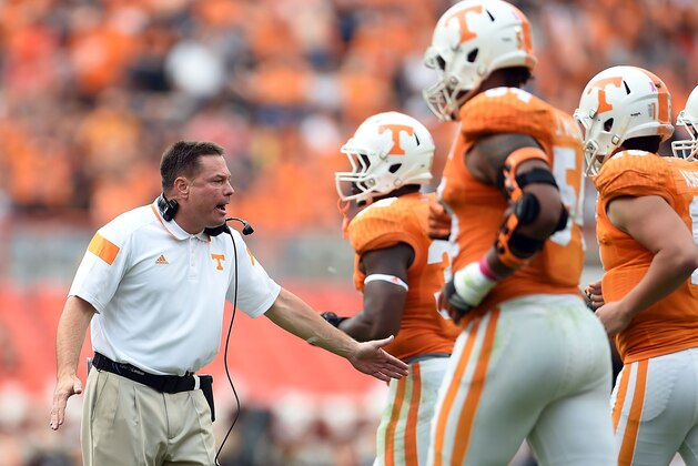 KNOXVILLE, TN - OCTOBER 11:  Head coach Butch Jones of the Tennessee Volunteers congratulates his players following a score against the Chattanooga Mocs during the second quarter of a game at Neyland Stadium on October 11, 2014 in Knoxville, Tennessee.  (Photo by Stacy Revere/Getty Images)