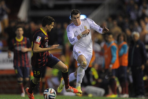 VALENCIA, SPAIN - APRIL 16:  Gareth Bale (R) of Real Madrid beats Marc Bartra   of Barcelona during the  Copa del Rey Final between Real Madrid and Barcelona at Estadio Mestalla on April 16, 2014 in Valencia, Spain.  (Photo by Denis Doyle/Getty Images)