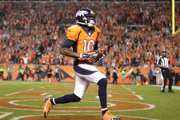 Denver Broncos wide receiver Emmanuel Sanders (10) scores his second touchdown of the game as San Diego Chargers cornerback Richard Marshall (31) defends during the first half of an NFL football game, Thursday, Oct. 23, 2014, in Denver. (AP Photo/Joe Mahoney)