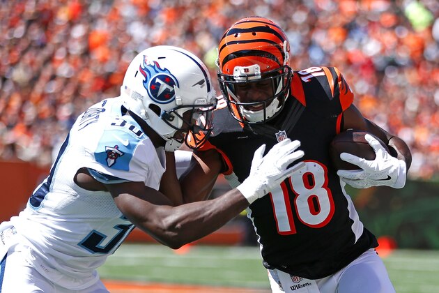CINCINNATI, OH - SEPTEMBER 21:  Jason McCourty #30 of the Tennessee Titans knocks A.J. Green #18 of the Cincinnati Bengals out of bounds during the first quarter at Paul Brown Stadium on September 21, 2014 in Cincinnati, Ohio. (Photo by Joe Robbins/Getty Images)