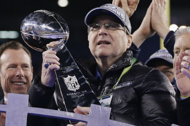 EAST RUTHERFORD, NJ - FEBRUARY 02:  Team owner Paul Allen of the Seattle Seahawks celebrates with the Vince Lombardi trophy after defeating the Denver Broncos 43-8 in Super Bowl XLVIII at MetLife Stadium on February 2, 2014 in East Rutherford, New Jersey.  (Photo by Kevin C. Cox/Getty Images)