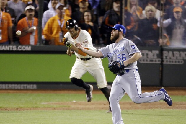 Kansas City Royals' Greg Holland throws to first for the final out on San Francisco Giants' Hunter Pence during the ninth inning of Game 3 of baseball's World Series Friday, Oct. 24, 2014, in San Francisco. The Royals won the game 3-2 to lead the series 2-1. (AP Photo/Charlie Riedel)