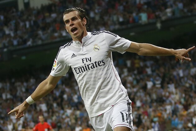 Real's Gareth Bale celebrates his goal during a Spanish La Liga soccer match between Real Madrid and Elche at the Santiago Bernabeu stadium in Madrid, Spain, Tuesday, Sept. 23, 2014. (AP Photo/Andres Kudacki)