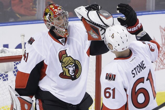 Ottawa Senators goalie Craig Anderson (41) and right wing Mark Stone (61) celebrate after the Senators defeated the Florida Panthers 1-0 in an NHL hockey game, Monday, Oct. 13, 2014 in Sunrise, Fla. (AP Photo/Wilfredo Lee)