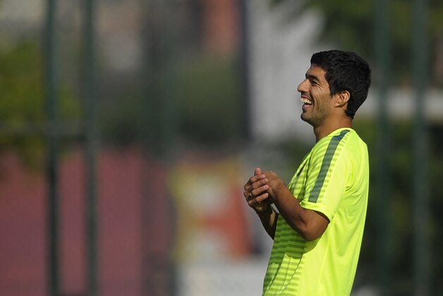 FC Barcelona's Luis Suarez, from Uruguay, laughs during a training session at the Sports Center FC Barcelona Joan Gamper in San Joan Despi, Spain, Monday, Oct. 20, 2014. FC Barcelona will play against Ajax in a group F Champions League on Tuesday Oct. 21. (AP Photo/Manu Fernandez)