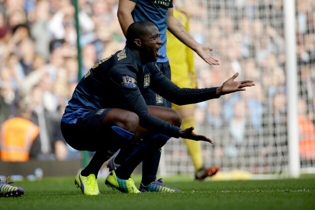 Manchester City's Yaya Toure reacts to a decision from the referee during the English Premier League soccer match between West Ham and Manchester City at Upton Park stadium in London, Saturday, Oct. 25, 2014.  (AP Photo/Matt Dunham)