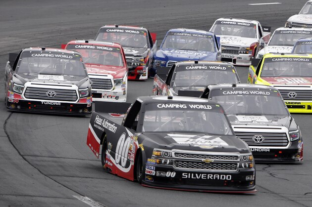 Cole Custer (00) grabs the lead on a restart during the NASCAR Camping World Truck Series at New Hampshire Motor Speedway, Saturday, Sept. 20, 2014, in Loudon, N.H. Custer went on to win the race. (AP Photo/Jim Cole)