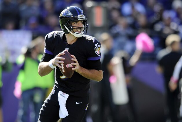 Baltimore Ravens quarterback Joe Flacco runs as he looks for a receiver in the first half of an NFL football game against the Atlanta Falcons, Sunday, Oct. 19, 2014, in Baltimore. (AP Photo/Gail Burton)