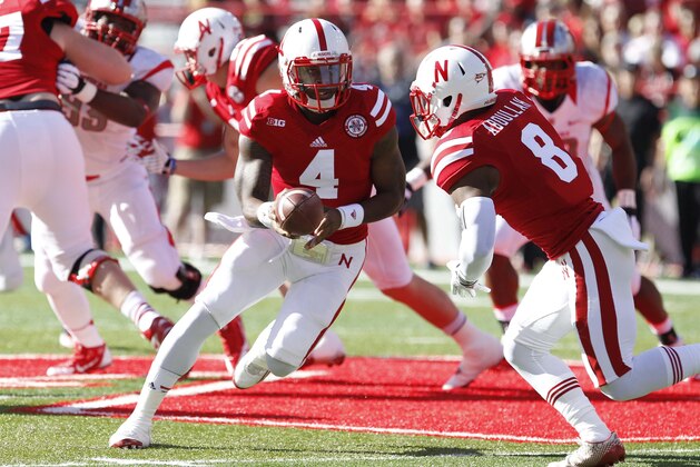 Oct 25, 2014; Lincoln, NE, USA; Nebraska Cornhuskers quarterback Tommy Armstrong Jr. (4) hands off to running back Ameer Abdullah (8) during the game against Rutgers Scarlet Knights in the first half at Memorial Stadium. Mandatory Credit: Bruce Thorson-USA TODAY Sports