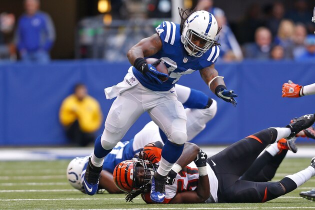 INDIANAPOLIS, IN - OCTOBER 19:  Trent Richardson #34 of the Indianapolis Colts breaks a tackle by Jayson DiManche #51 of the Cincinnati Bengals during the first quarter on October 19, 2014 at Lucas Oil Stadium on October 19, 2014 in Indianapolis, Indiana. (Photo by Kirk Irwin/Getty Images)