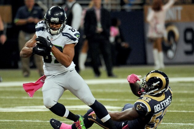Seattle Seahawks wide receiver Doug Baldwin, left, slips past St. Louis Rams linebacker Alec Ogletree after catching a pass for a 49-yard gain during the first quarter of an NFL football game Sunday, Oct. 19, 2014, in St. Louis. (AP Photo/L.G. Patterson)