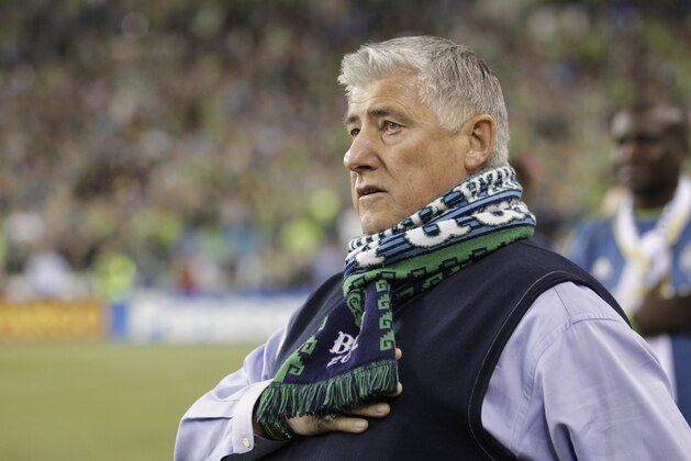 Seattle Sounders head coach Sigi Schmid stands on the sideline during the National Anthem before an MLS soccer match against the Real Salt Lake, Friday, Sept 12, 2014 in Seattle. (AP Photo/Stephen Brashear)