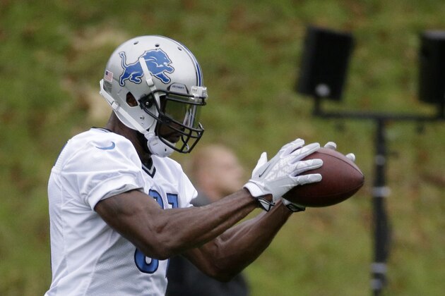 Detroit Lions wide receiver Calvin Johnson, who is recovering from an injury, catches a ball during a training session at Pennyhill Park Hotel in Bagshot, England, Thursday, Oct. 23, 2014.  The Atlanta Falcons will play the Detroit Lions in an NFL football game at London's Wembley Stadium on Sunday.  (AP Photo/Matt Dunham)