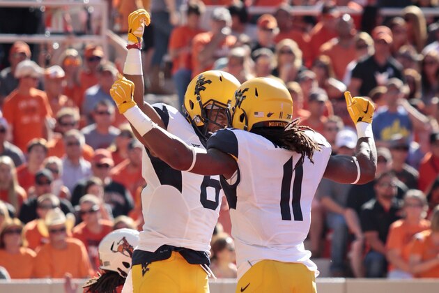 STILLWATER, OK - OCTOBER 25:   Wide receiver Daikiel Shorts #6 and wide receiver Kevin White #11 of the West Virginia Mountaineers celebrate a touchdown against Oklahoma State October 25, 2014 at Boone Pickens Stadium in Stillwater, Oklahoma. (Photo by Brett Deering/Getty Images)