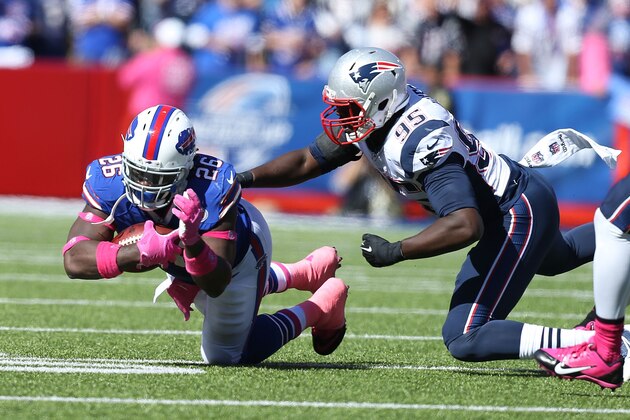 ORCHARD PARK, NY - OCTOBER 12:   Anthony Dixon #26 of the Buffalo Bills is tackled by Chandler Jones #95 of the New England Patriots during the first half at Ralph Wilson Stadium on October 12, 2014 in Orchard Park, New York.  (Photo by Brett Carlsen/Getty Images)