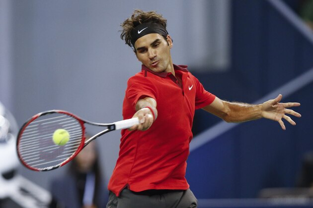 Roger Federer of Switzerland returns a shot against Gilles Simon of France for men's singles final match at the Shanghai Masters Tennis Tournament in Shanghai, China, Sunday, Oct. 12, 2014.  (AP Photo/Vincent Thian)