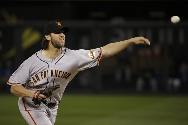 San Francisco Giants pitcher Madison Bumgarner throws during the first inning of Game 1 of baseball's World Series against the Kansas City Royals Tuesday, Oct. 21, 2014, in Kansas City, Mo. (AP Photo/Matt Slocum )