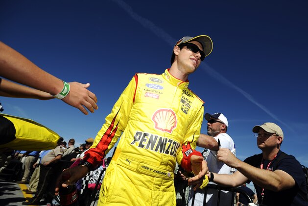 Joey Logano is greeted by fans before the NASCAR Sprint Cup Series auto race at Talladega Superspeedway Sunday, Oct. 19, 2014, in Talladega, Ala. (AP Photo/Rainier Ehrhardt)