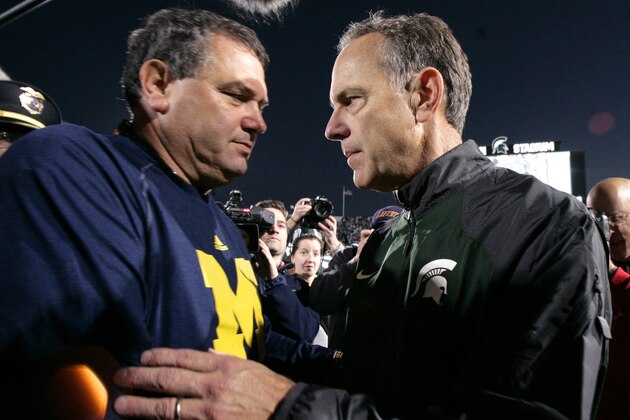 Michigan coach Brady Hoke, left, and Michigan State coach Mark Dantonio shake hands following an NCAA college football game, Saturday, Oct. 25, 2014, in East Lansing, Mich. Michigan State won 35-11. (AP Photo/Al Goldis)