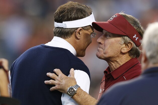 South Carolina coach Steve Spurrier, right, greets Auburn coach Gus Malzahn before an NCAA college football game Saturday, Oct. 25, 2014, in Auburn, Ala. (AP Photo/Brynn Anderson)