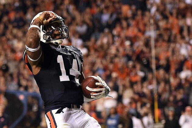 AUBURN, AL - OCTOBER 25:  Nick Marshall #14 of the Auburn Tigers celebrates a touchdown during the third quarter of a game against the South Carolina Gamecocks at Jordan Hare Stadium on October 25, 2014 in Auburn, Alabama.  (Photo by Stacy Revere/Getty Images)