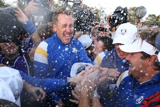 Europe team members including Ian Poulter, center, and Victor Dubuisson, right, celebrate with champagne after winning the 2014 Ryder Cup golf tournament at Gleneagles, Scotland, Sunday, Sept. 28, 2014. (AP Photo/Peter Morrison)