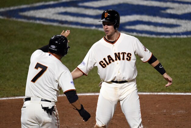 Oct 25, 2014; San Francisco, CA, USA; San Francisco Giants catcher Buster Posey (right) celebrates with center fielder Gregor Blanco (7) after scoring a run against the Kansas City Royals in the sixth inning during game four of the 2014 World Series at AT&T Park. Mandatory Credit: Ed Szczepanski-USA TODAY Sports
