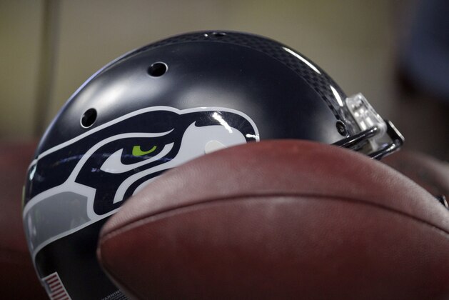 A Seattle Seahawks helmet and football are seen during the fourth quarter of an NFL football game between the St. Louis Rams and the Seattle Seahawks Sunday, Oct. 19, 2014, in St. Louis. The Rams won 28-26. (AP Photo/Tom Gannam)