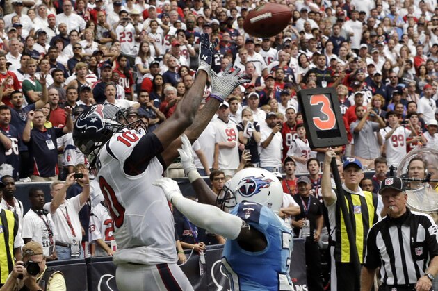Houston Texans' DeAndre Hopkins (10) catches the winning touchdown over Tennessee Titans' Jason McCourty, right, during overtime of an NFL football game on Sunday, Sept. 15, 2013, in Houston. (AP Photo/David J. Phillip)