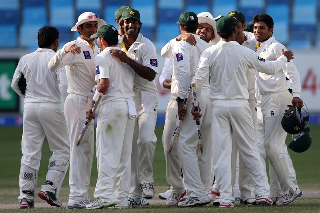 Pakistani players celebrate after they win Australia during day five of the First Test at Dubai International Stadium in United Arab Emirates, Sunday, Oct. 26, 2014. (AP Photo/Kamran Jebreili)